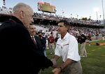 John Arrillaga, left, shakes hands with then Stanford football coach Walt Harris in 2006.