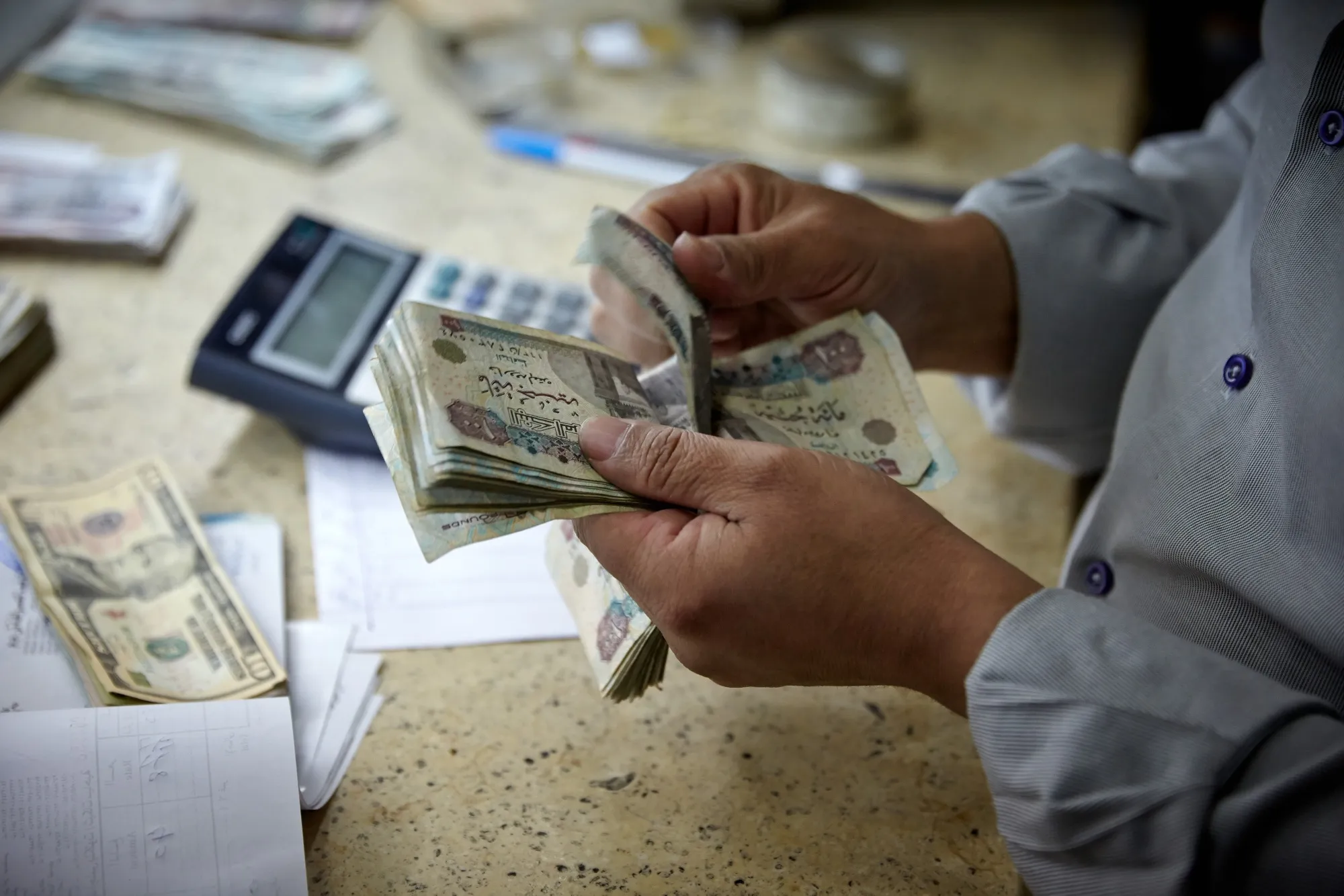 A person counts Egyptian pounds banknotes&nbsp;in Cairo, Egypt.