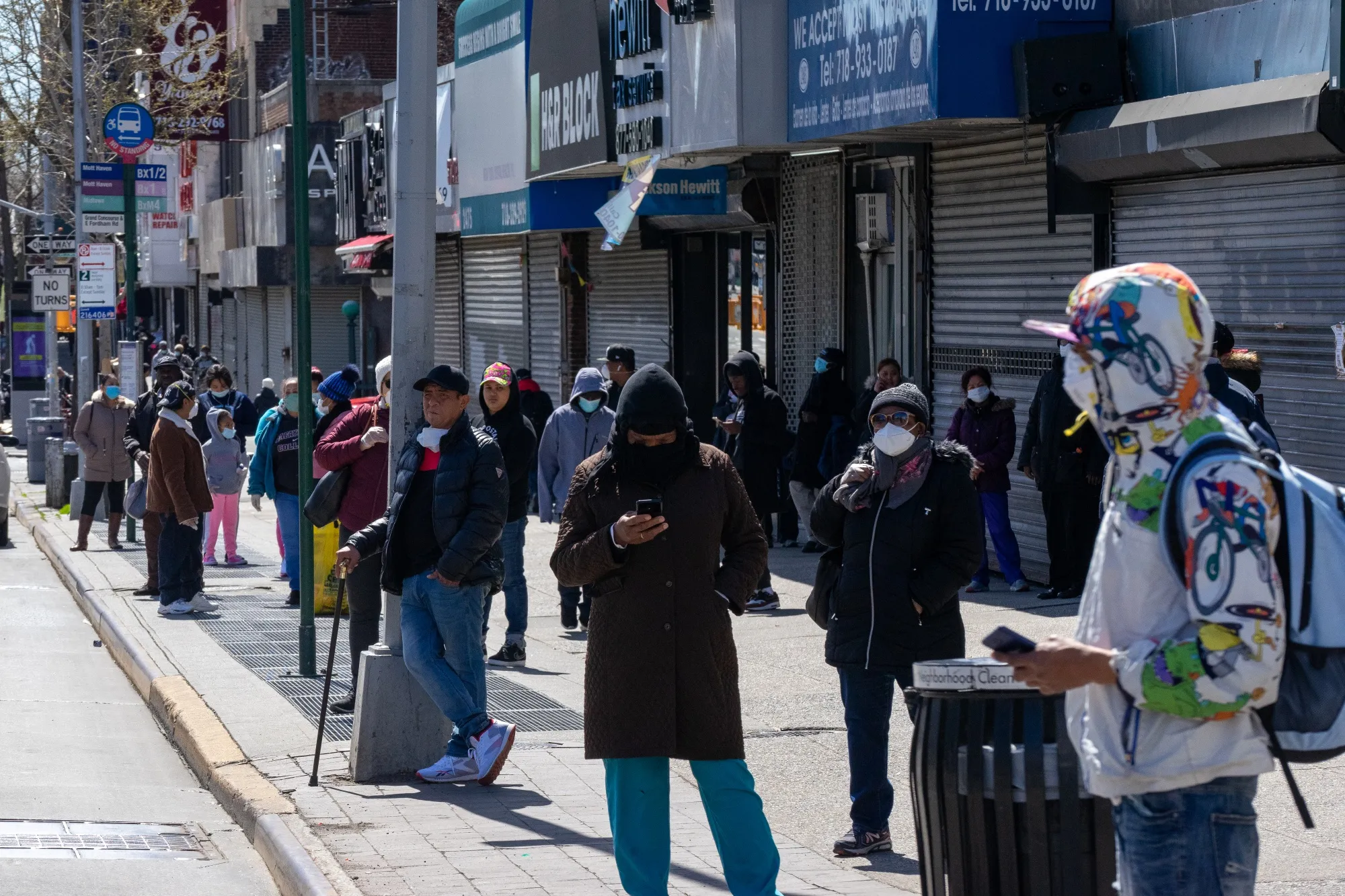 Commuters wait for a bus&nbsp;in the Bronx borough of New York on April 2.