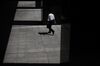 A man walks through the forecourt of a building in Tokyo, Japan, on Monday, June 5, 2017. Japan's revised first-quarter gross domestic product (GDP) figures will be released on June 8th.