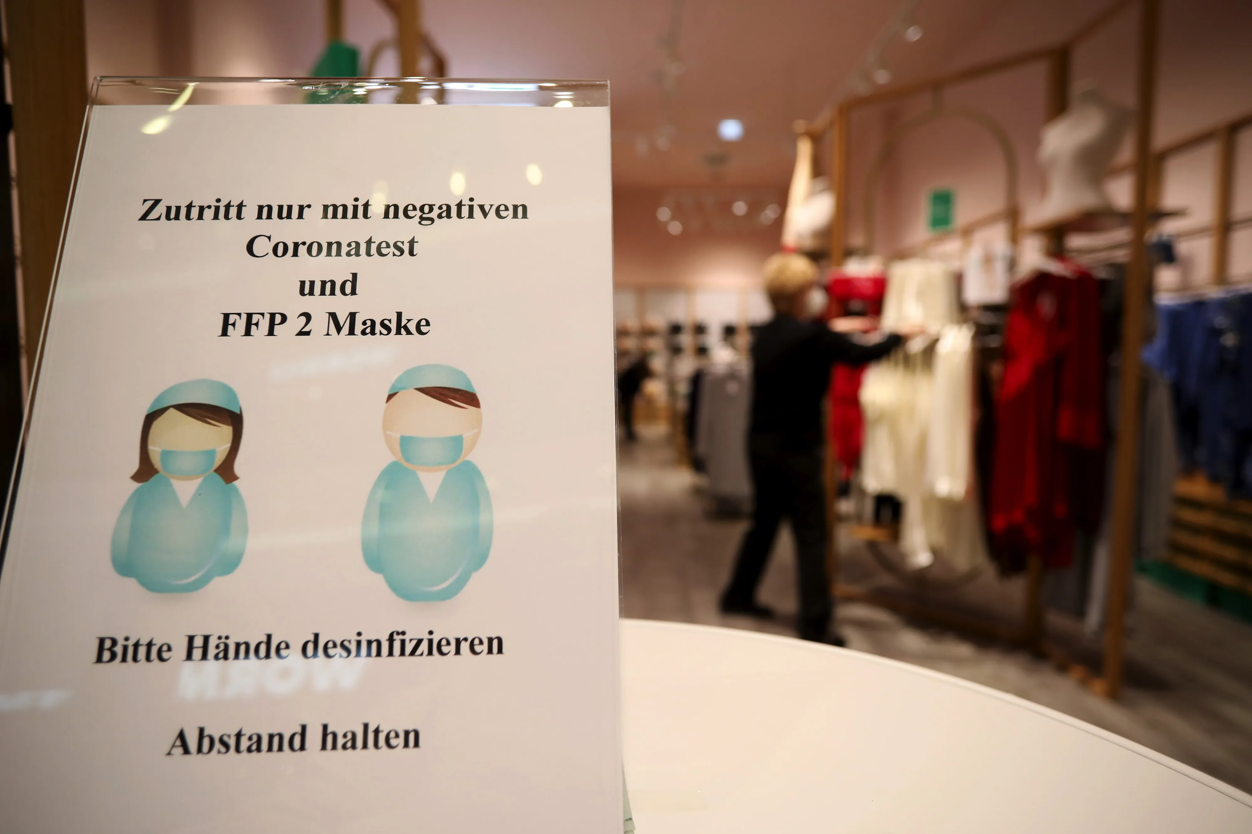 Strict virus entry rules apply to visitors in a clothing store at the Mall of Berlin in Berlin, Germany.