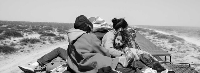 Adriana Joselin Sanchez Padilla, and her daughters, Mariana and Fernanda, ride on top of a cargo train in Mexico.
