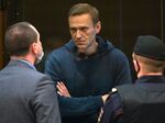 Alexey Navalny speaks to a lawyer in Moscow City Court on Feb. 2.