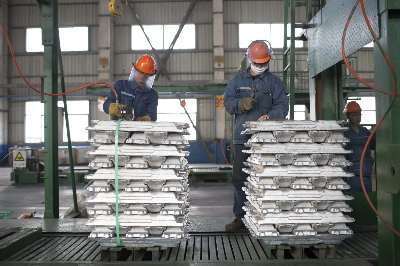 Employees package aluminum ingots at the China Hongqiao Group Ltd. aluminum smelting facility in Zouping, Shandong province, China.