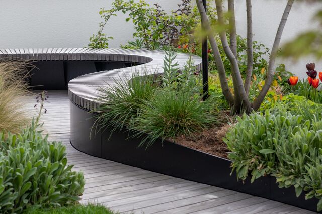 A wooden walkway on a rooftop garden of a home in Frankfurt. 