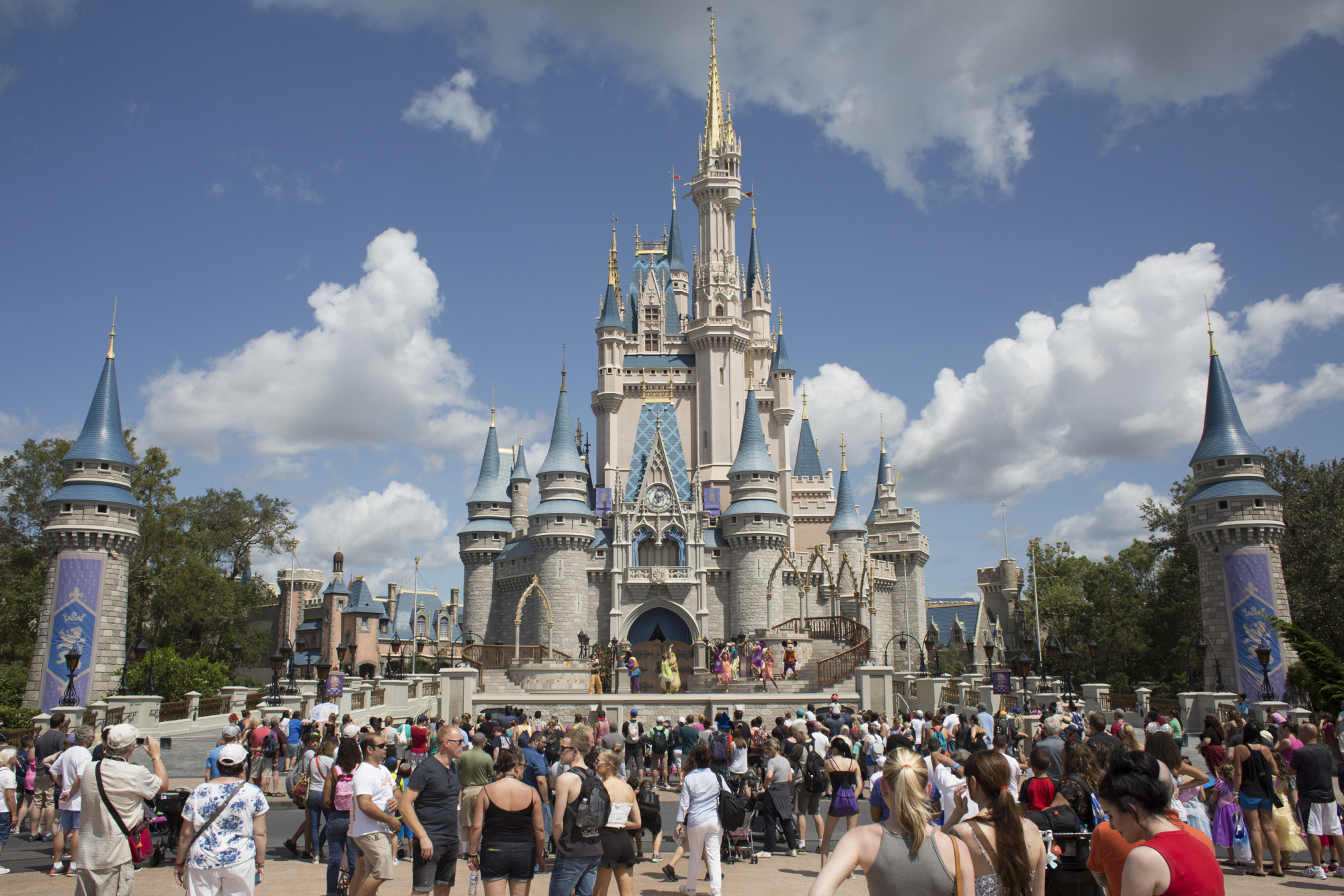 Visitors watch a performance at the Cinderella Castle at the Walt Disney Co. Magic Kingdom park in Orlando, Florida, U.S..&nbsp;