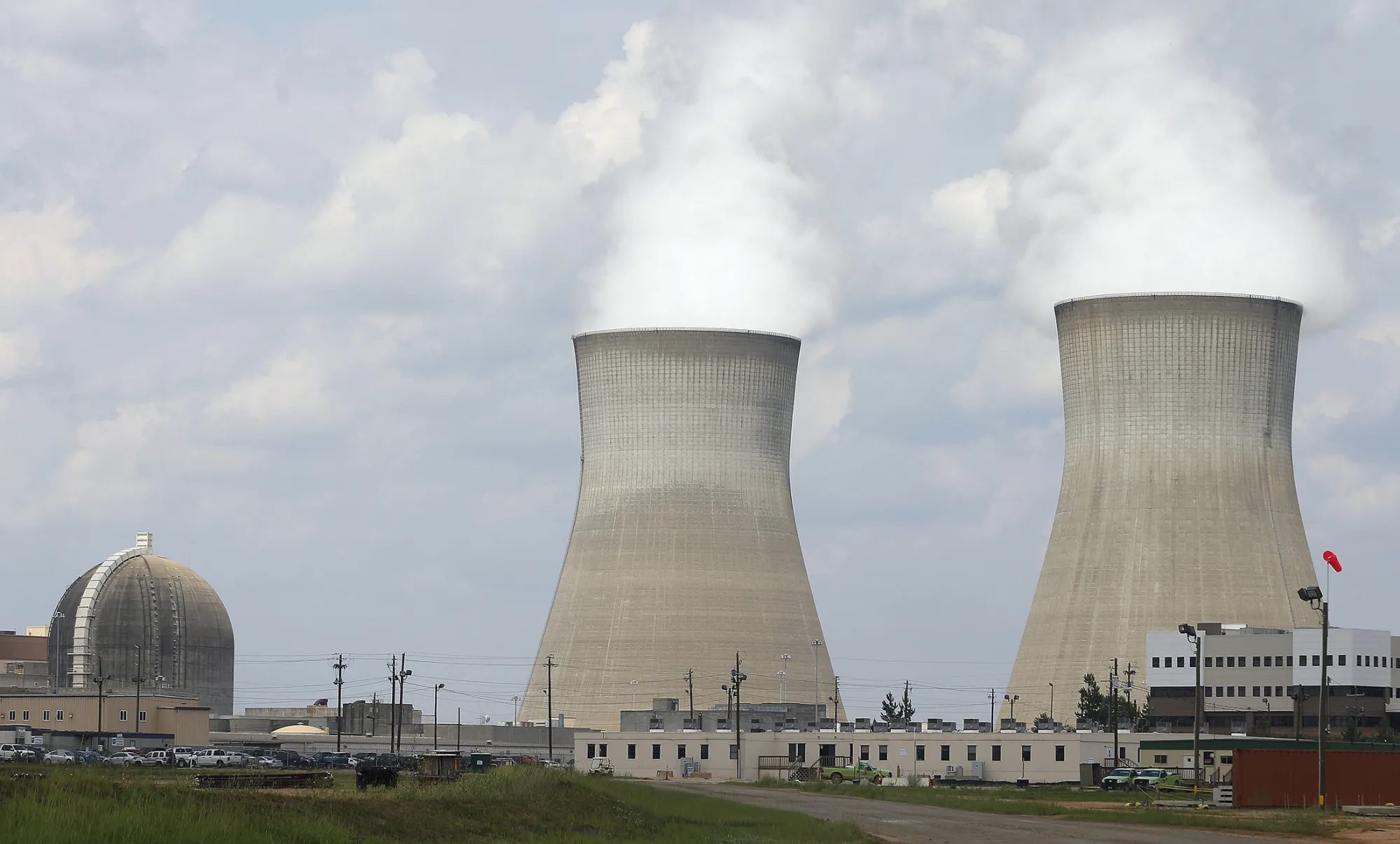 FILE - This Friday, June 13, 2014, file photo, shows the cooling towers, right, and nuclear reactor containment buildings area, left, at Plant Vogtle Nuclear Power Plant in Waynesboro, Ga. Westinghouse Electric Co., the U.S. nuclear unit of Japans Toshiba Corp., filed for bankruptcy protection Wednesday, March 29, 2017, calling into question the future of a number of billion-dollar nuclear projects under construction, including two in the U.S. (AP Photo/John Bazemore, File)
