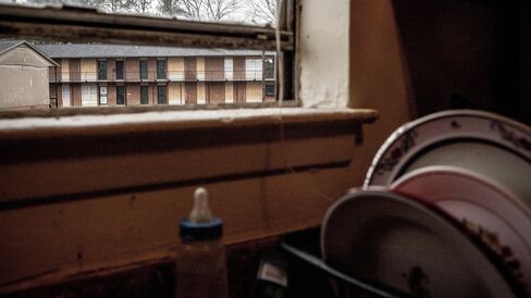 Boarded up windows to condemned units.