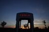 A Tesla Inc. Supercharger station stands illuminated at dusk in Rubigen, Switzerland.