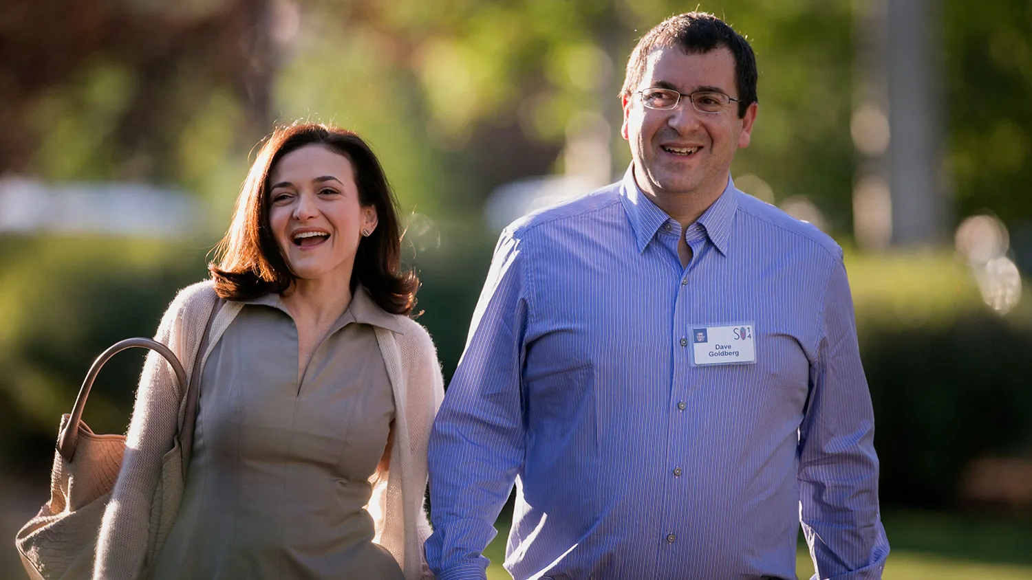 Sheryl Sandberg, chief operating officer of Facebook Inc., left, and her husband David and quot;Dave and quot; Goldberg, chief executive officer of SurveyMonkey, arrive to a morning session at the Sun Valley Lodge during the Allen and Co. Media and Technology Conference in Sun Valley, Idaho, U.S., on Wednesday, July 9, 2014.
