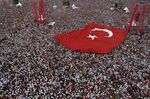 Crowds hold a huge Turkish national flag in Istanbul, Turkey.