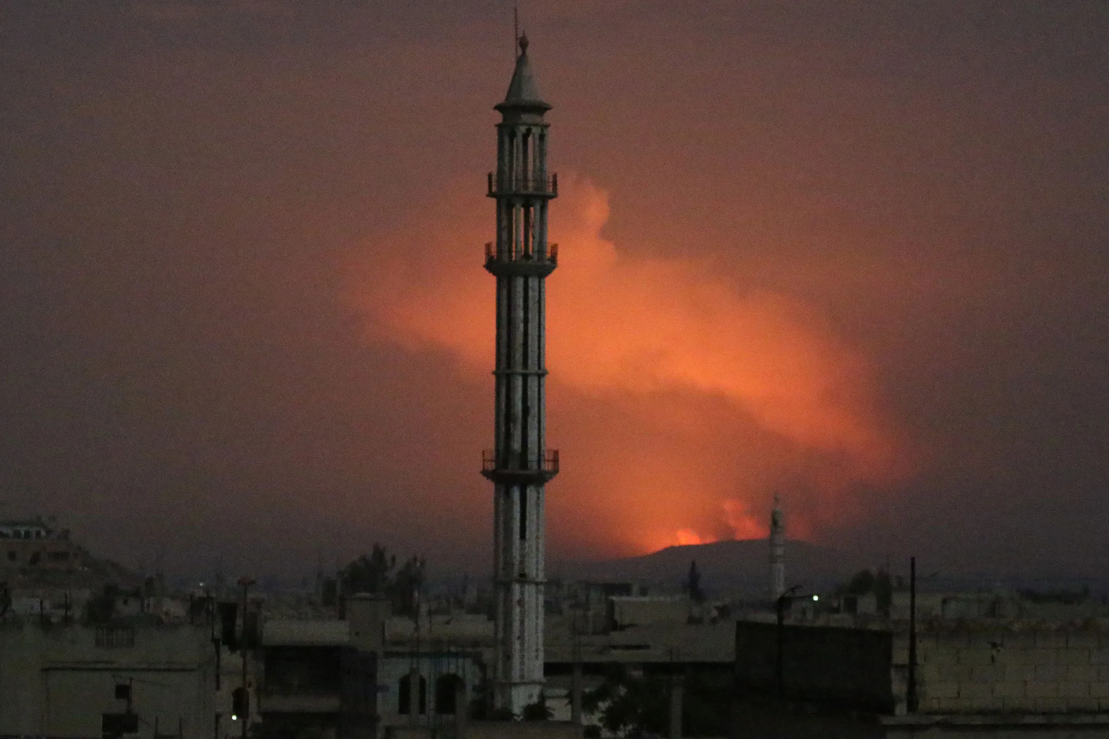 &nbsp;Smoke rises after military points of the 47th regiment of the Assad regime were hit in Hama on April 30.