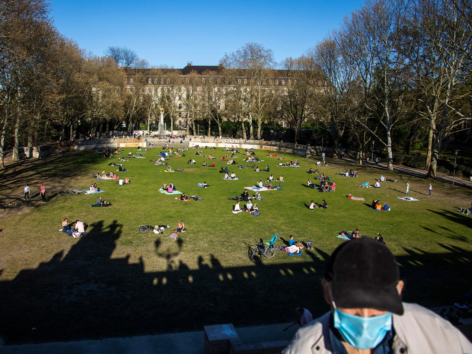 Sunbathers lie&nbsp;in the park next to Schoeneberg town hall in Berlin on April 18.