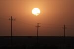 The sun rises over power lines near Imperial, California.