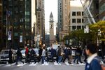 Pedestrians cross a street in the financial district of Toronto.