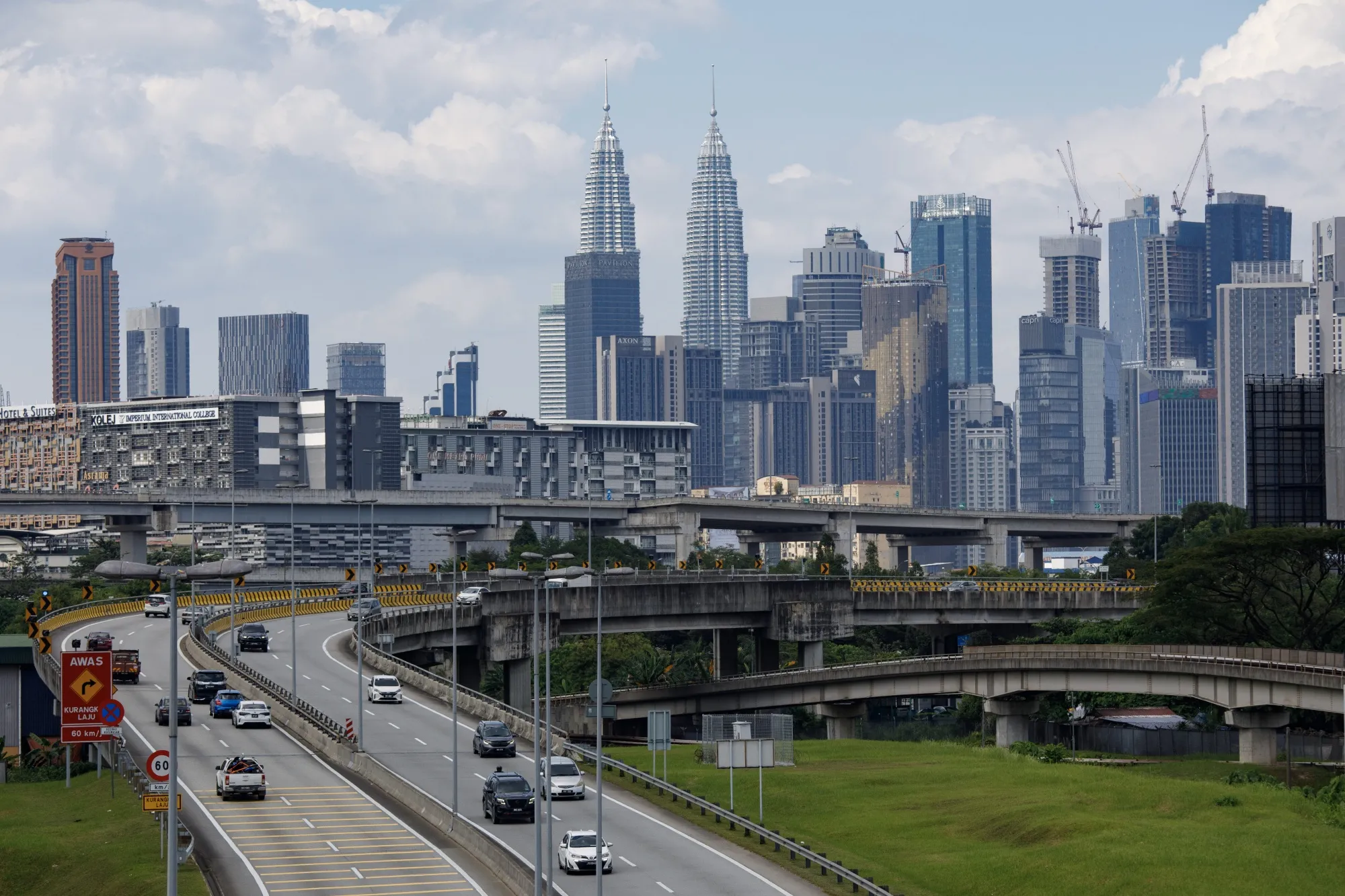 The Petronas Twin Towers, center, and other buildings in Kuala Lumpur.