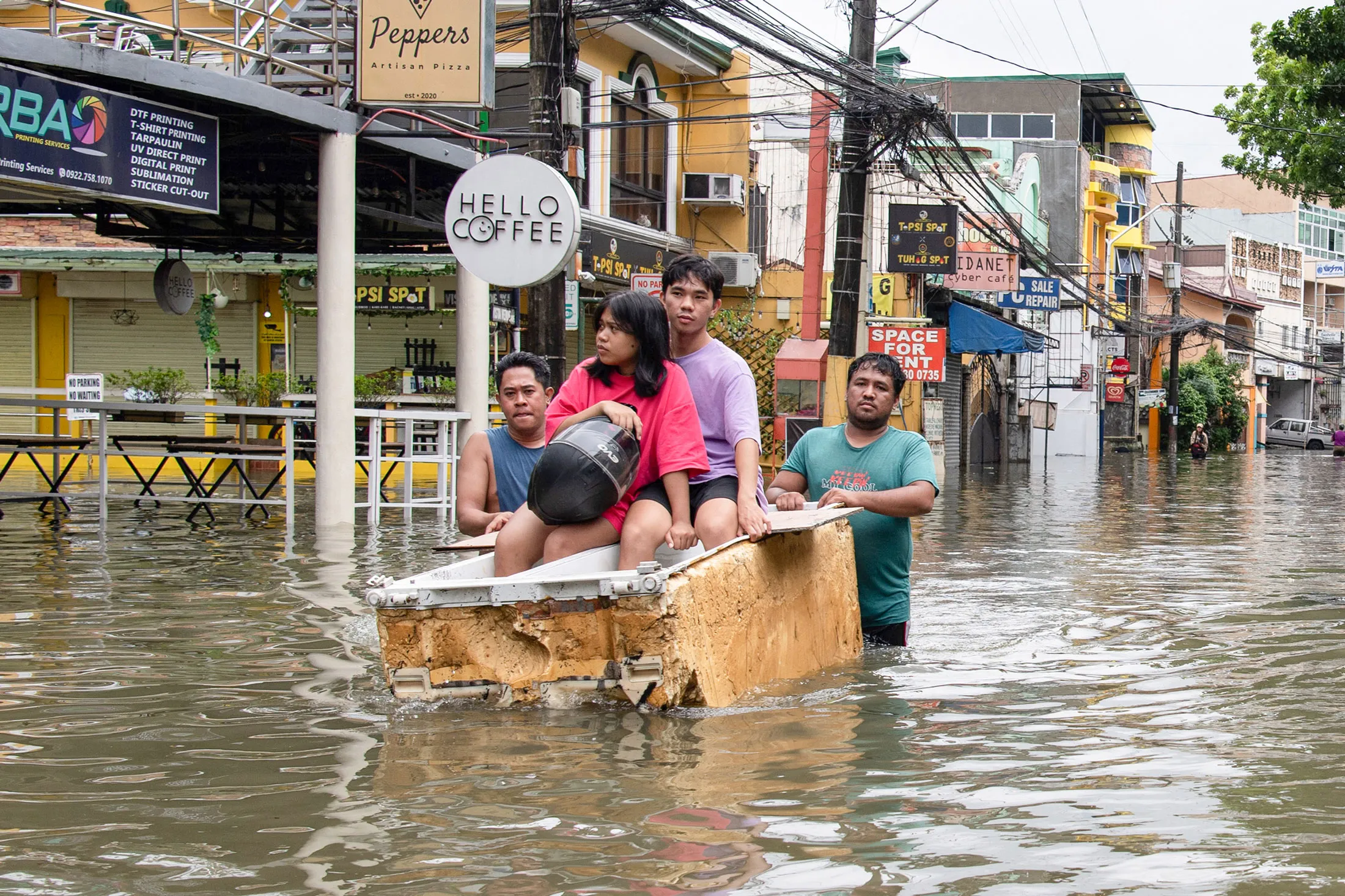 People wade through high waters east of Manila on July 22.