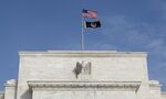 Flags fly above the Federal Reserve building in Washington, D.C., U.S.