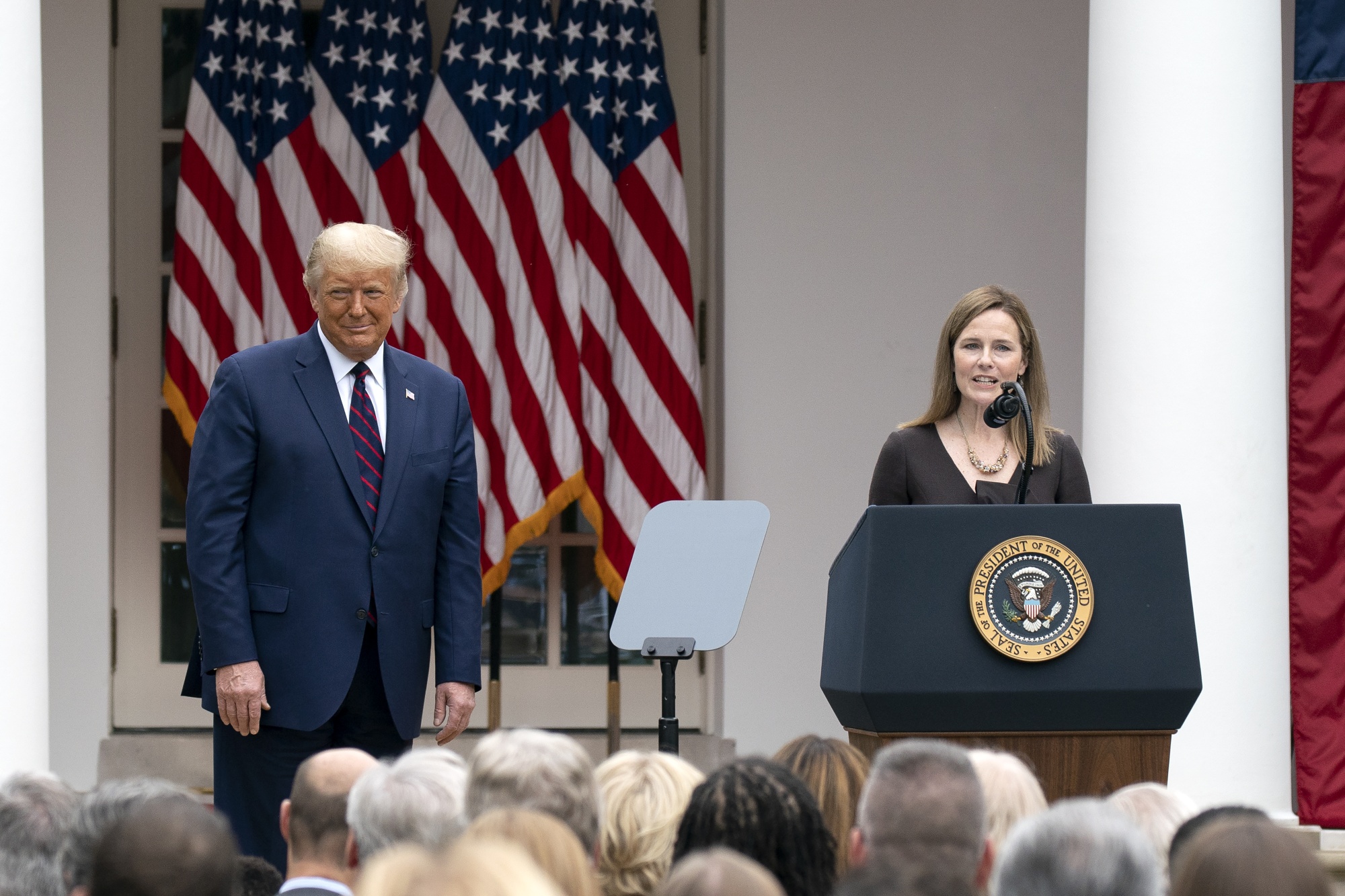 Amy Coney Barrett speaks as President Donald Trump listens during an announcement ceremony at the White House in Washington, D.C., on Saturday, Sept. 26.