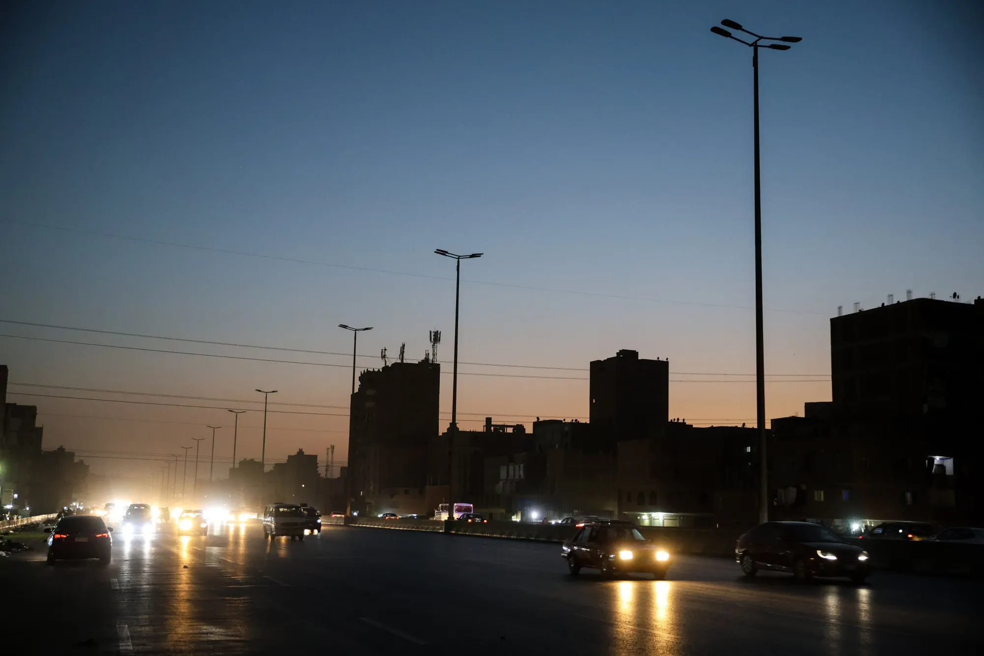 Unlit street lighting on a city road during a load shedding power outage period in Cairo, Egypt&nbsp;on June 7.