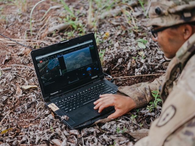 A soldier uses a computer to operate a Ghost-X drone during a training exercise at the Jungle Operations Training Center at Lightning Academy on Honolulu, Hawaii.