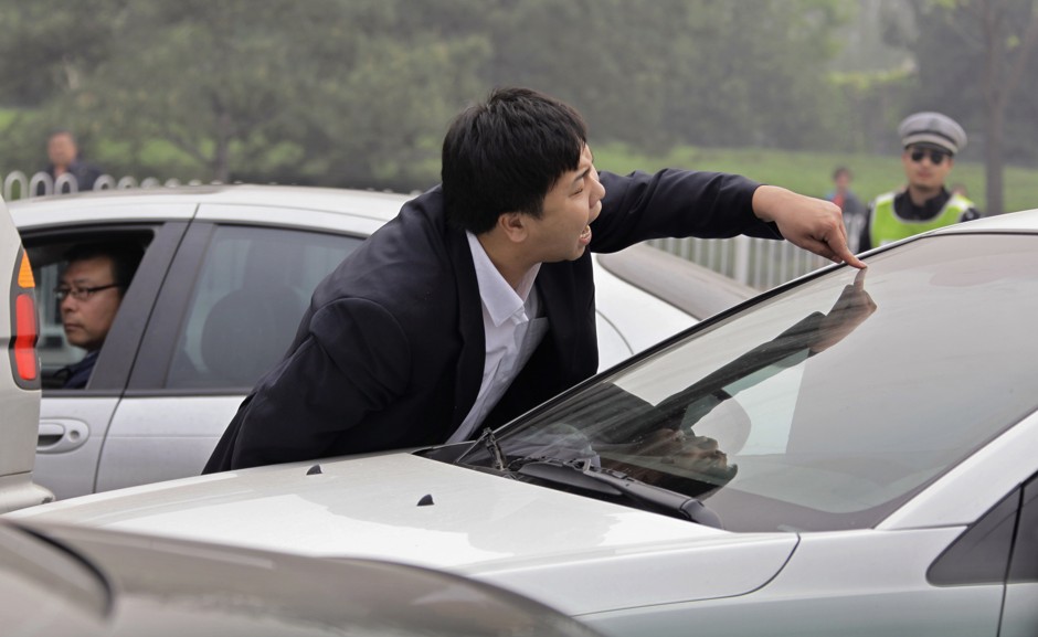 An angry driver in Beijing shouts at another motorist during a traffic jam in 2012. 