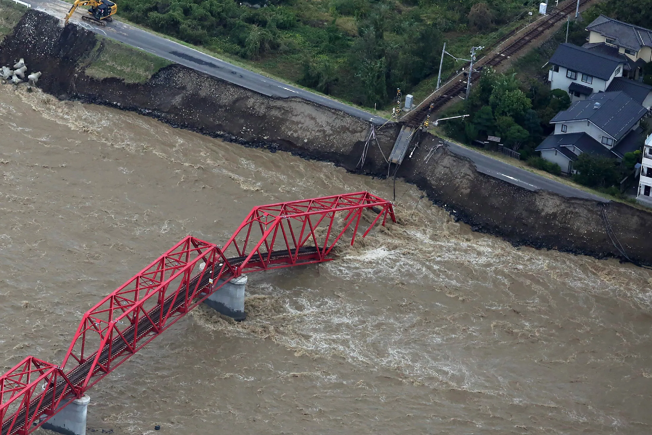 A damaged train bridge over the swollen Chikuma river in Nagano prefecture on Oct. 13.