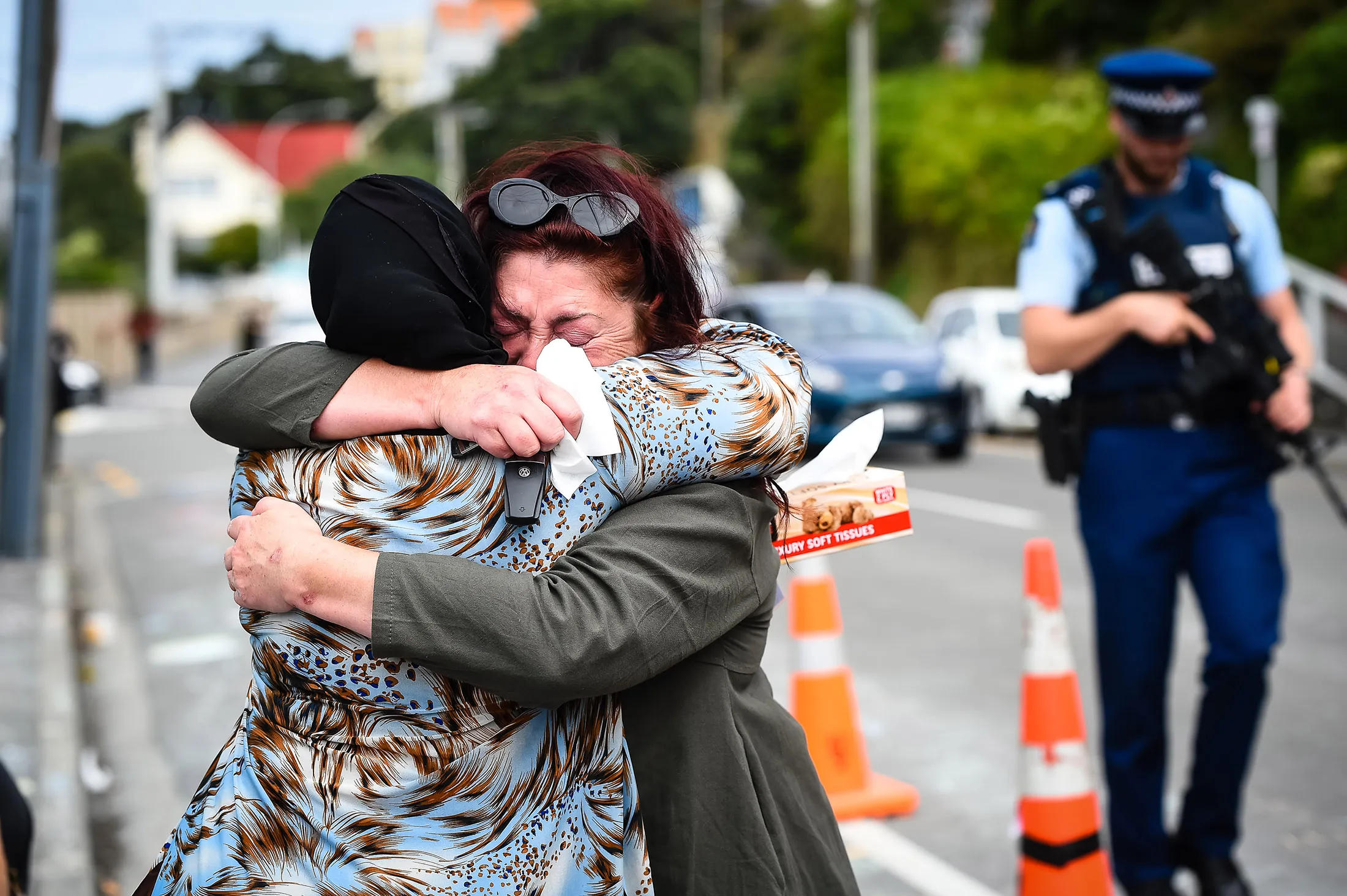 People embrace at the Kilbirnie Mosque on March 17.