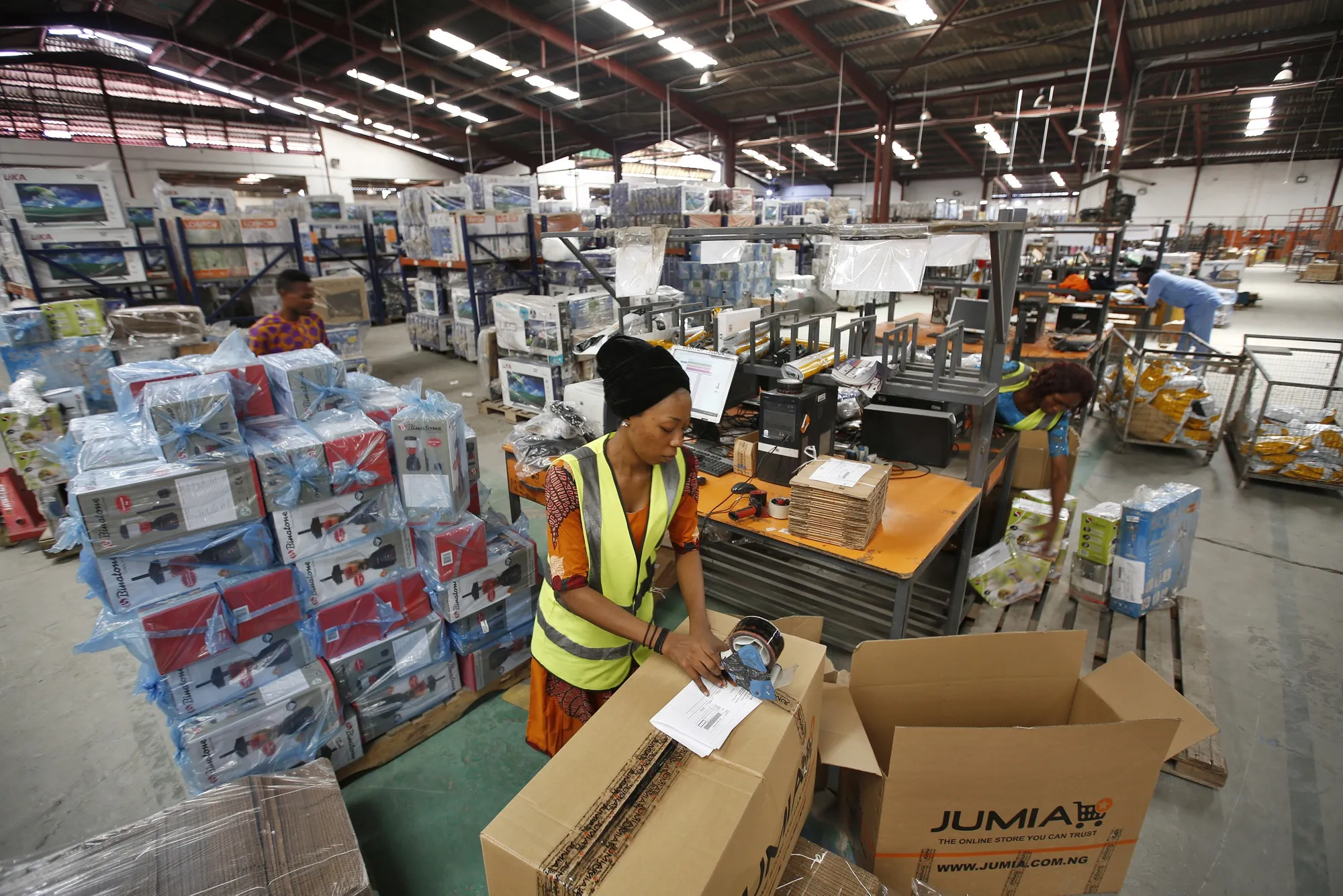 A worker packages goods&nbsp;inside a Jumia Technologies AG distribution warehouse in Lagos.