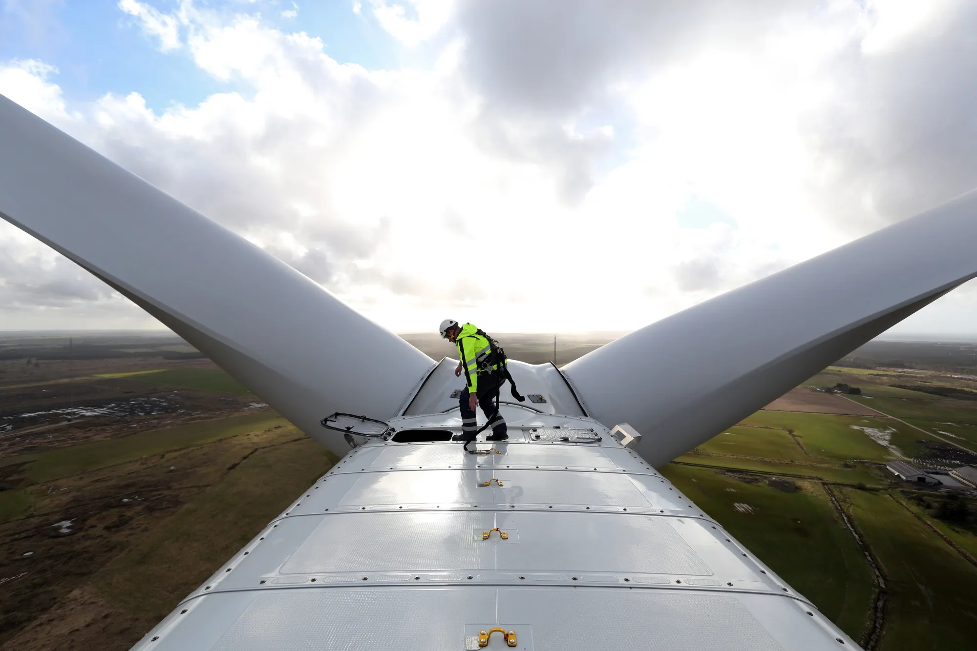 An employee prepares to exit the nacelle of a Vestas V136 wind turbine&nbsp;in Osterild, Denmark.