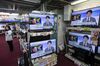 Televisions being sold at an Onoden Co. electronics store display an image of North Korean leader Kim Jong Un during a news report on North Korea's missile launch in Tokyo, Japan.