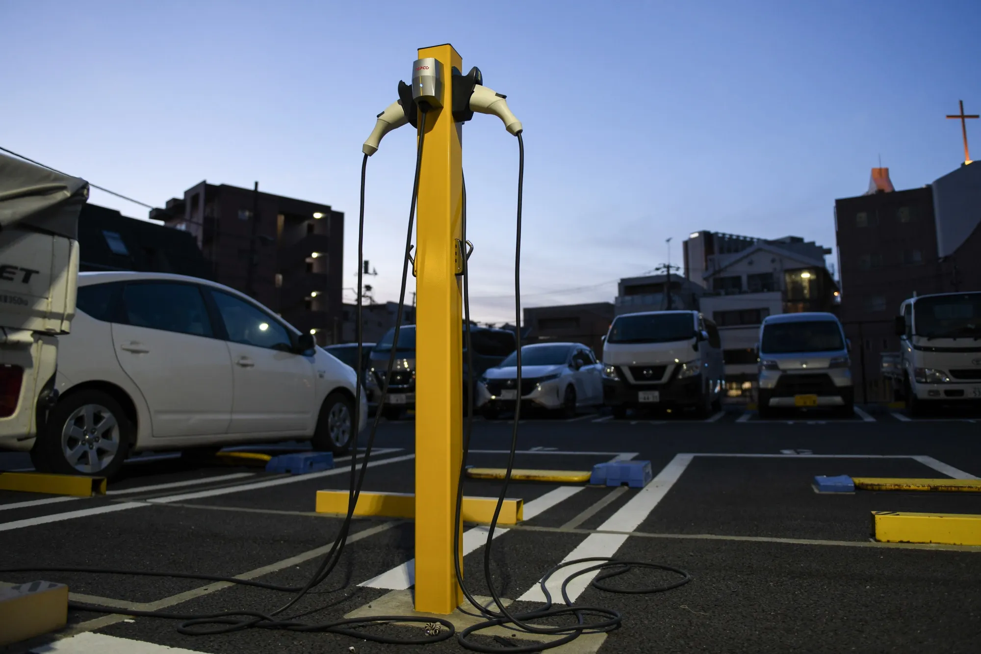 EV charging connectors at Park24 parking lot in Tokyo.