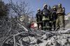 Palestinian firefighters (L) from the West Bank city of Jenin and an Israeli security forces member (R) arrive to help extinguish a fire in the northern Israeli city of Haifa following a wildfire, on November 25, 2016.Tens of thousands of Israelis fled raging bushfires in the northern city of Haifa on November 24, as Prime Minister Benjamin Netanyahu said any proof of arson would be treated as 'terror'. Ayman Odeh, the head of the Arab block in the Israeli parliament, said in a statement that many of the fires had disproportionately affected Arab areas, including in Haifa where he is from. / AFP / JACK GUEZ (Photo credit should read JACK GUEZ/AFP/Getty Images)
