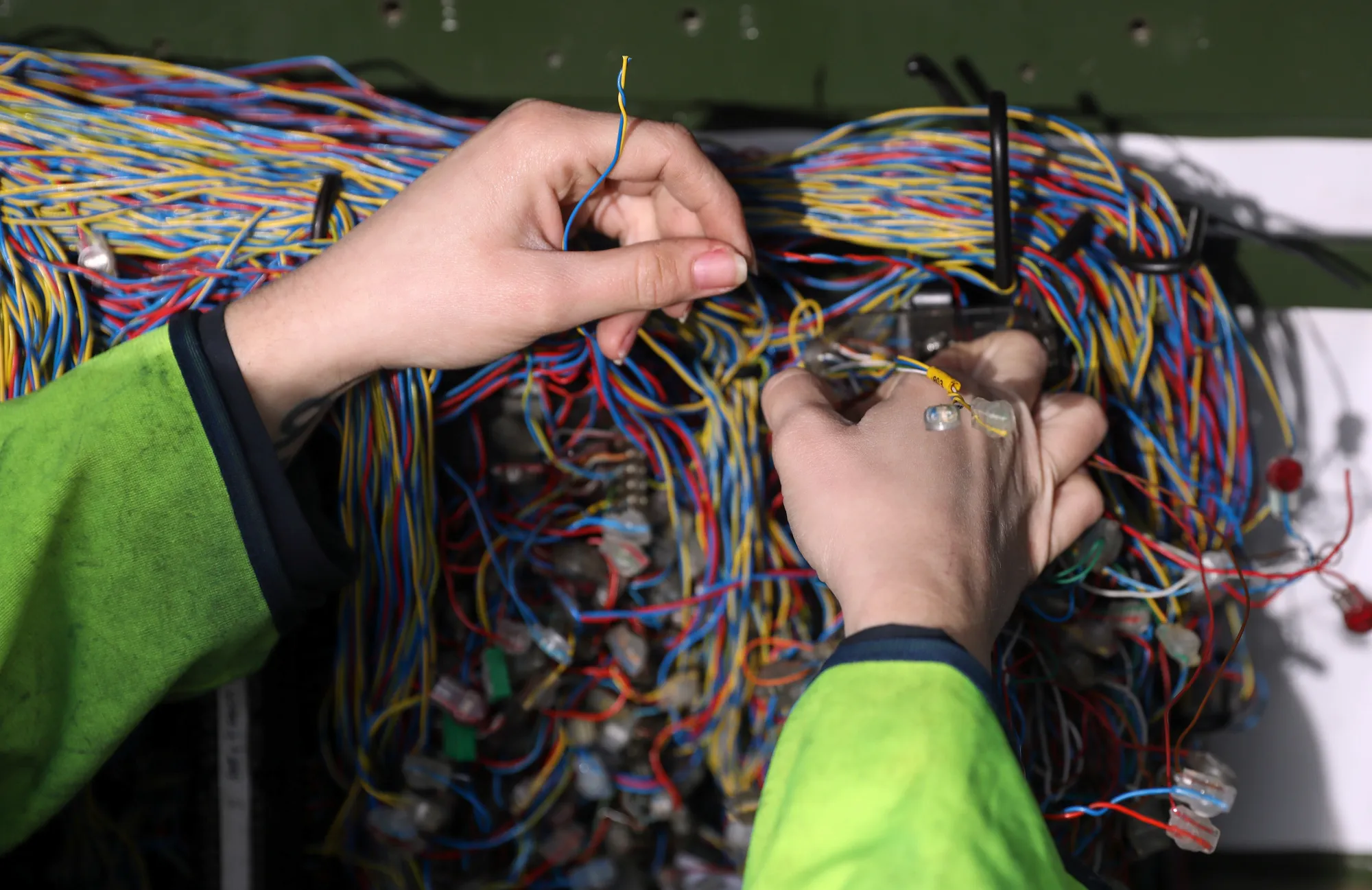 A network engineer from Openreach, a unit of BT Group Plc, connects wires inside a primary connection point box in this arranged photograph in Upminster, U.K., on Thursday, Nov. 10, 2016