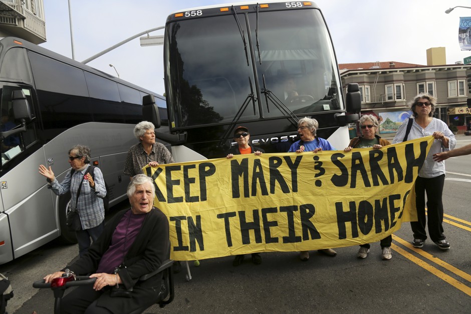 Protestors block a Google bus in San Francisco on August 1, 2014.