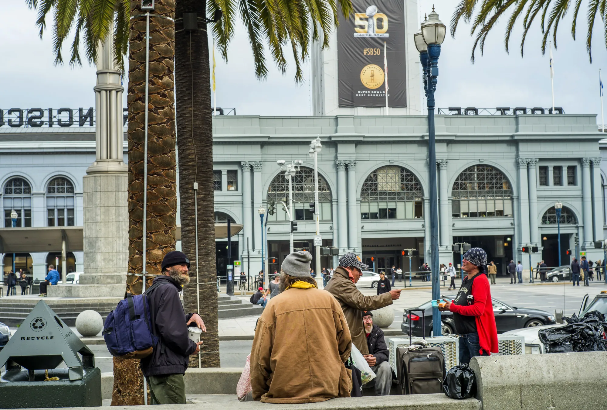 People loiter in front of the Ferry Building.
