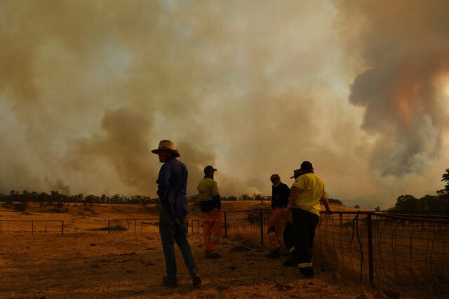 Farmhand Matt Hood views a flank of a fire on January 11, 2020 in Tumburumba, Australia. 