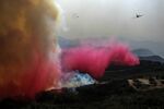 An air tanker drops retardant on a wildfire Wednesday, Oct. 13, 2021, in Goleta, Calif.   (AP Photo/Ringo H.W. Chiu)