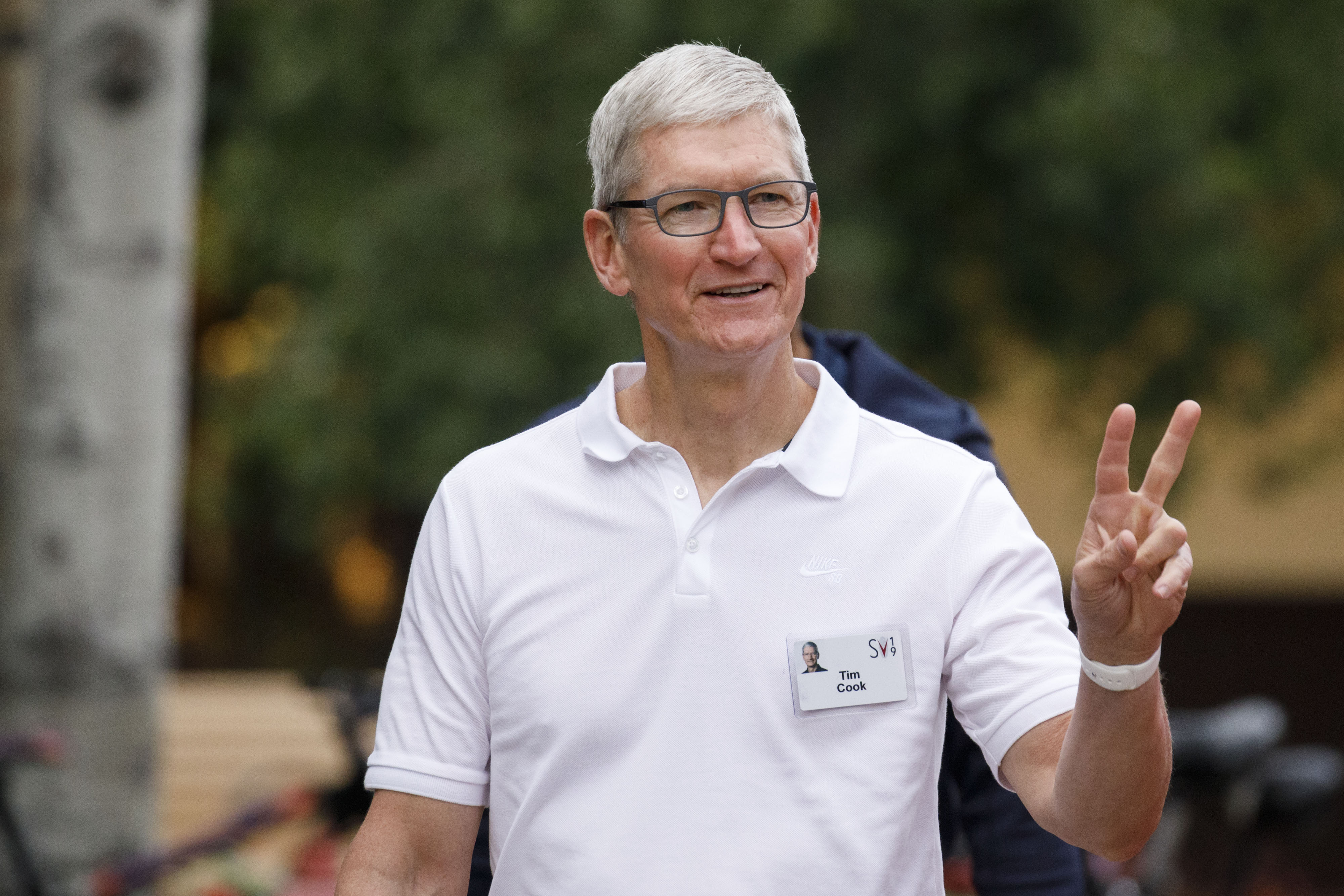 Tim Cook, chief executive officer of Apple Inc., gives a peace sign while arriving for the morning session of the Allen &amp; Co. Media and Technology Conference in Sun Valley, Idaho&nbsp;on July 10, 2019.
