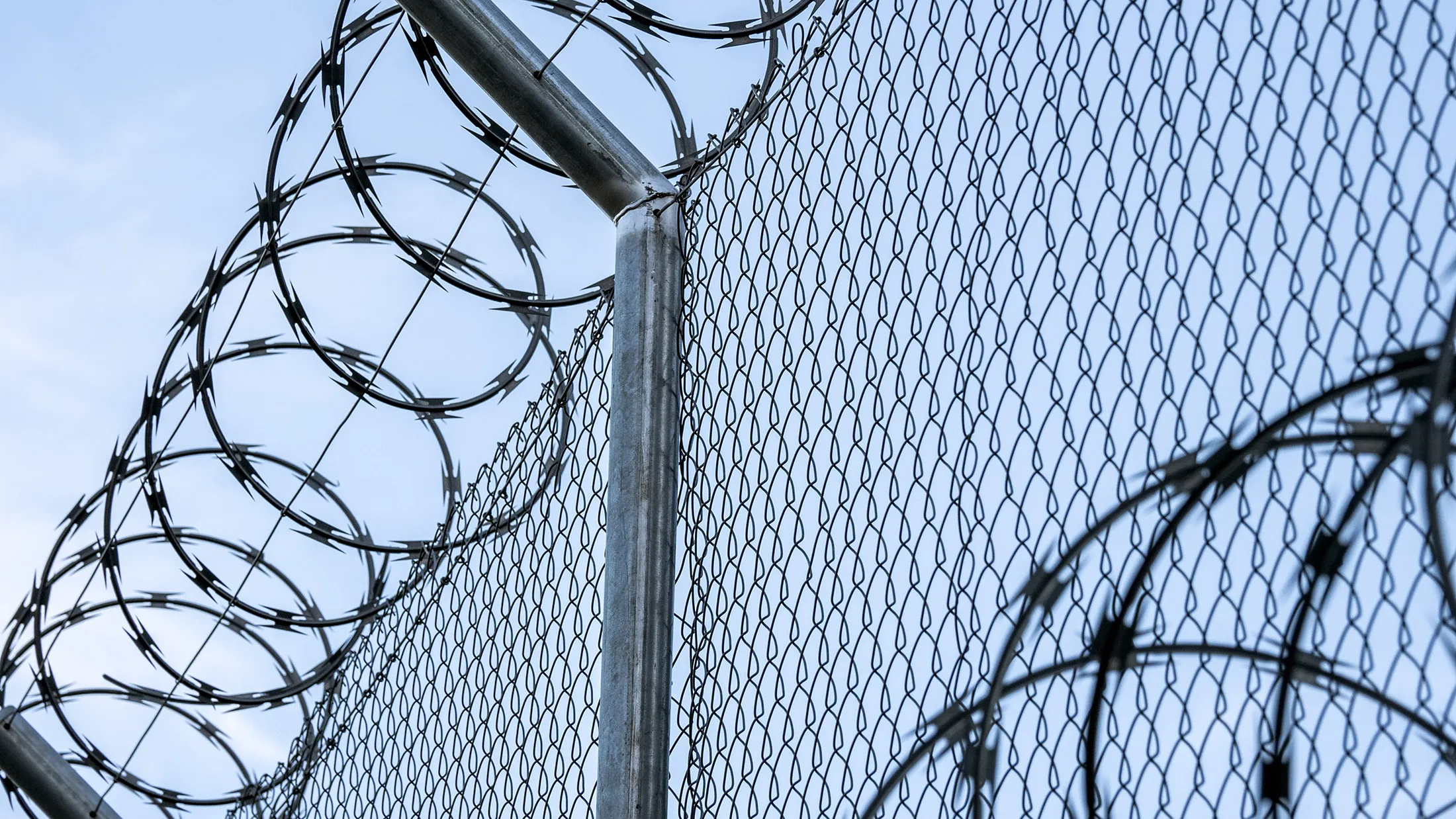 Metal fence with barbed wire. RF
