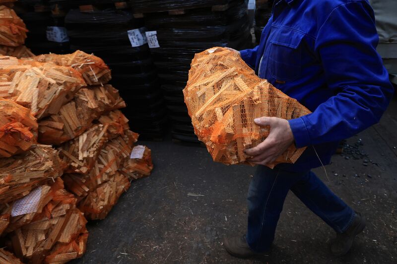 A supplier unloads bags of firewood at the Hans Engelke Energie OHG depot in Berlin, on Oct. 5.