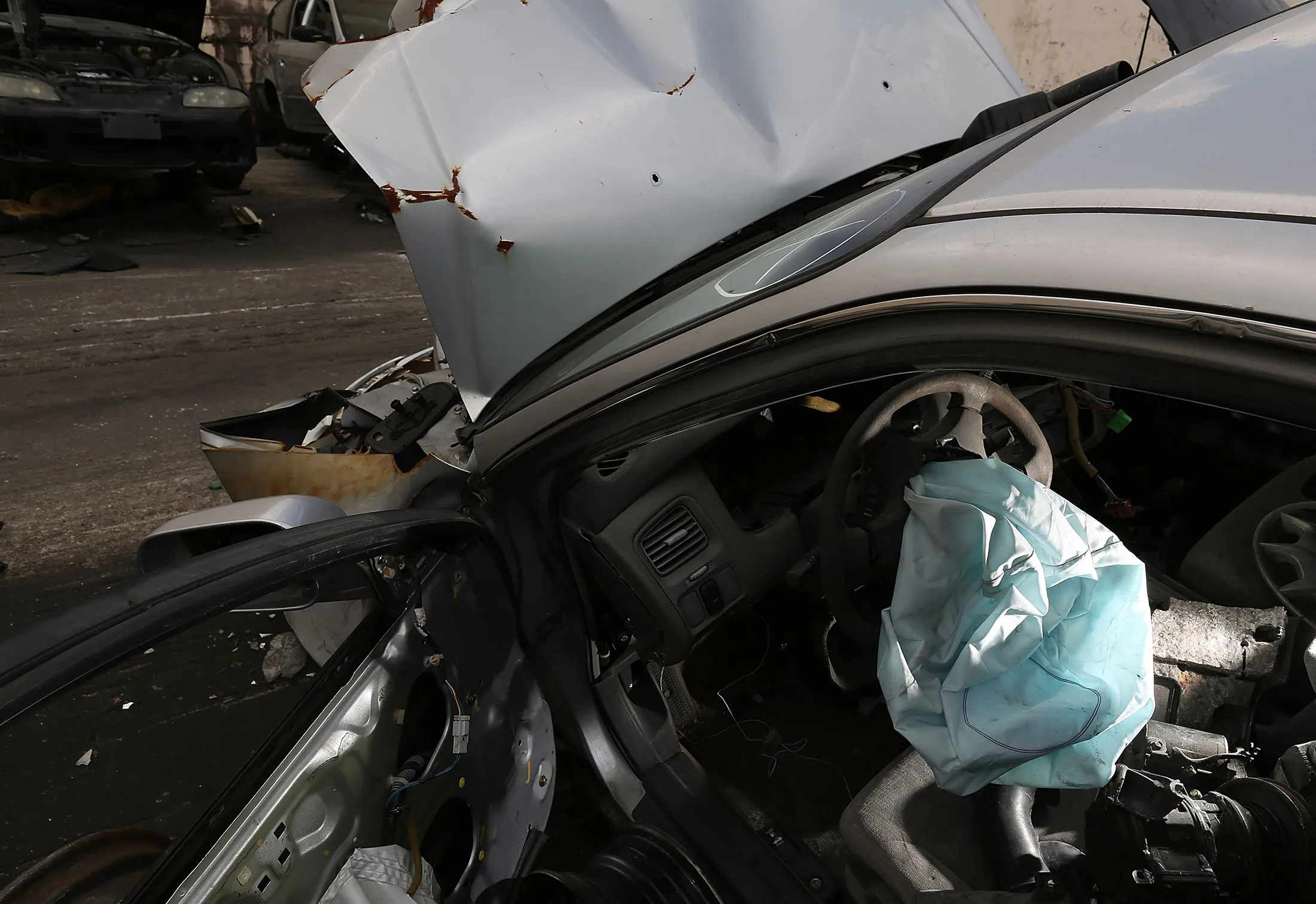 A deployed airbag is seen in a Honda vehicle at a salvage yard in 2015.