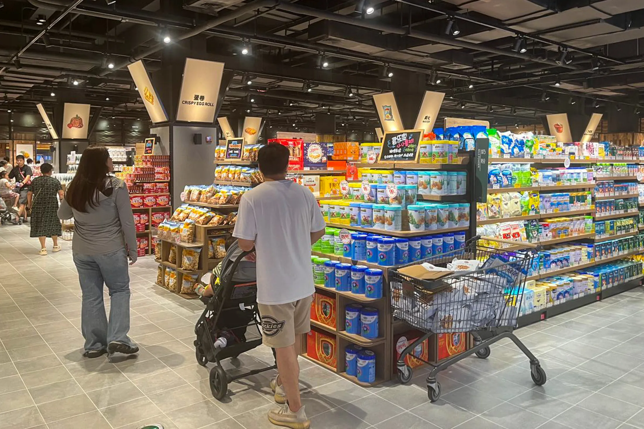 Shoppers browse a Pangdonglai store in Xuchang, China, in July.