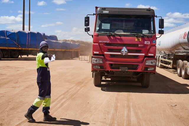 A border worker directs trucks at the Kasumbalesa border.