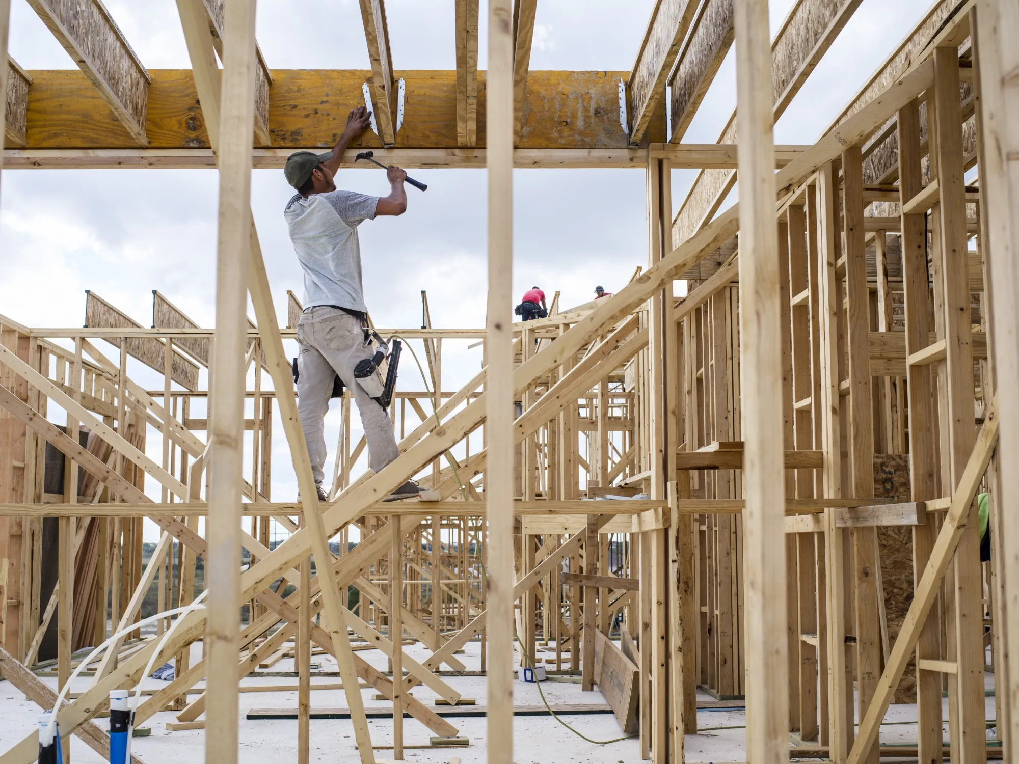 Construction workers frame a new home in Buda, Texas.