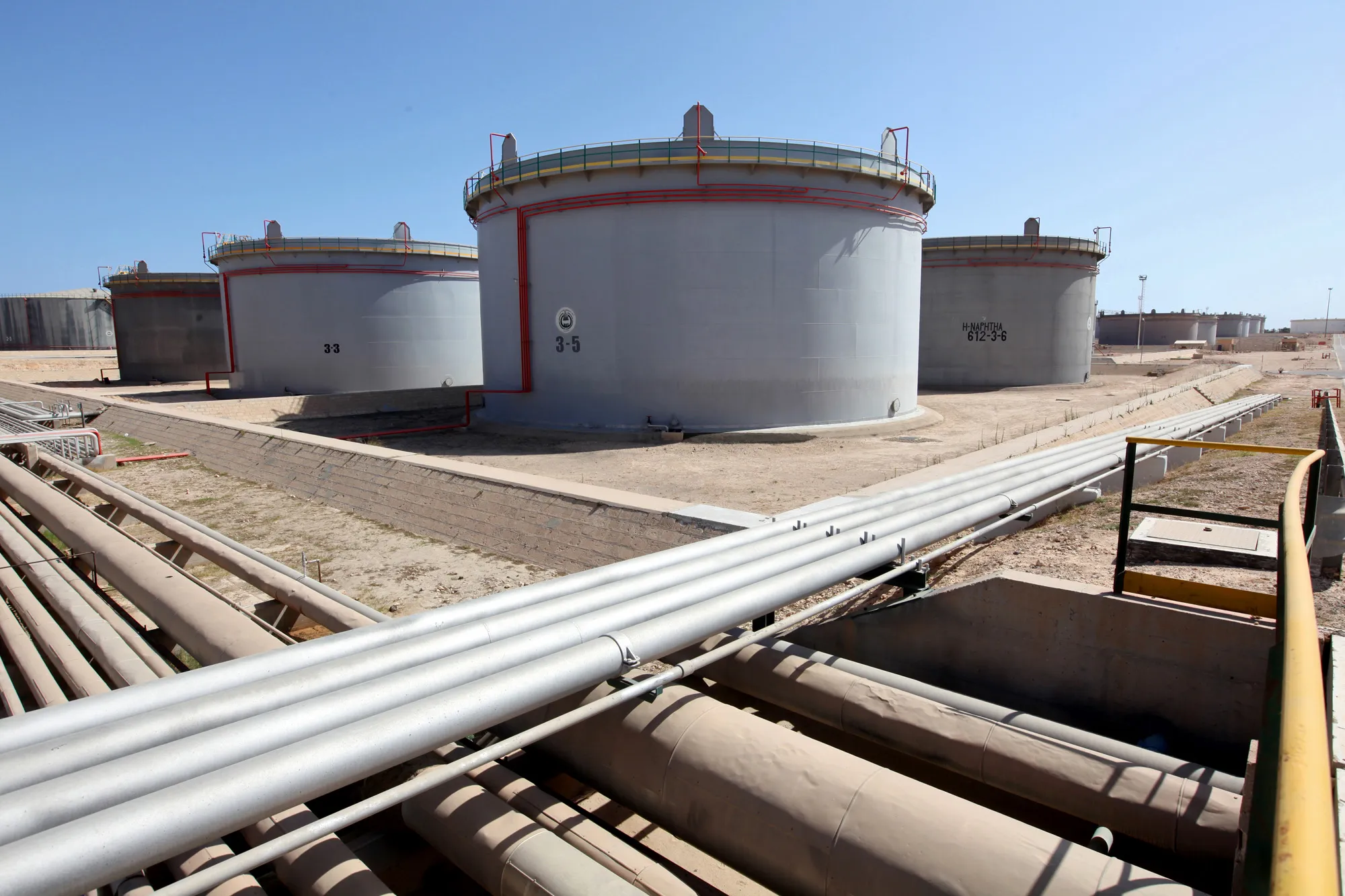 Pipes and fuel storage tanks at an oil refinery near Tripoli, Libya.