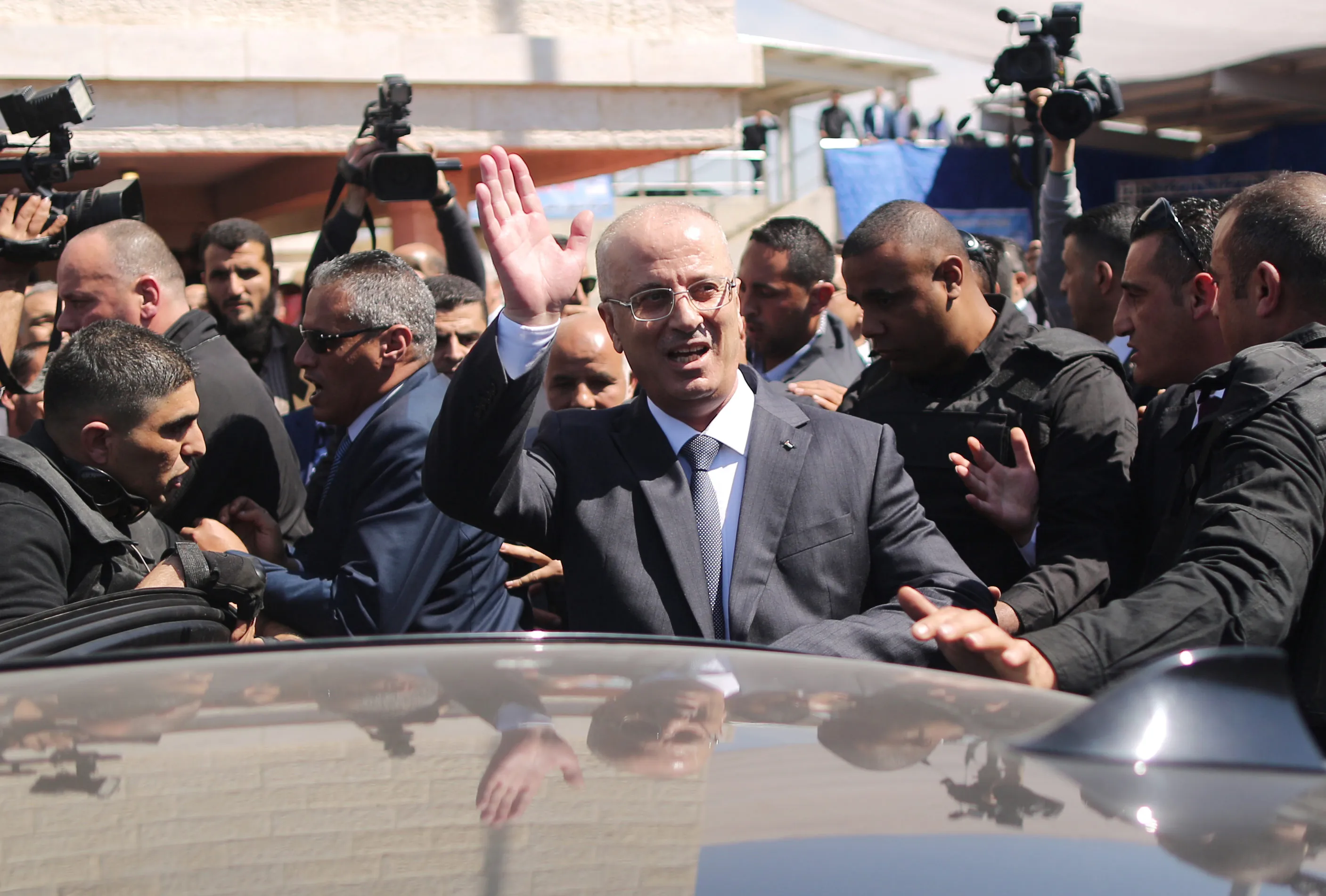 Palestinian Prime Minister Rami Hamdallah waves to the crowd upon his arrival in Gaza City on March 13.