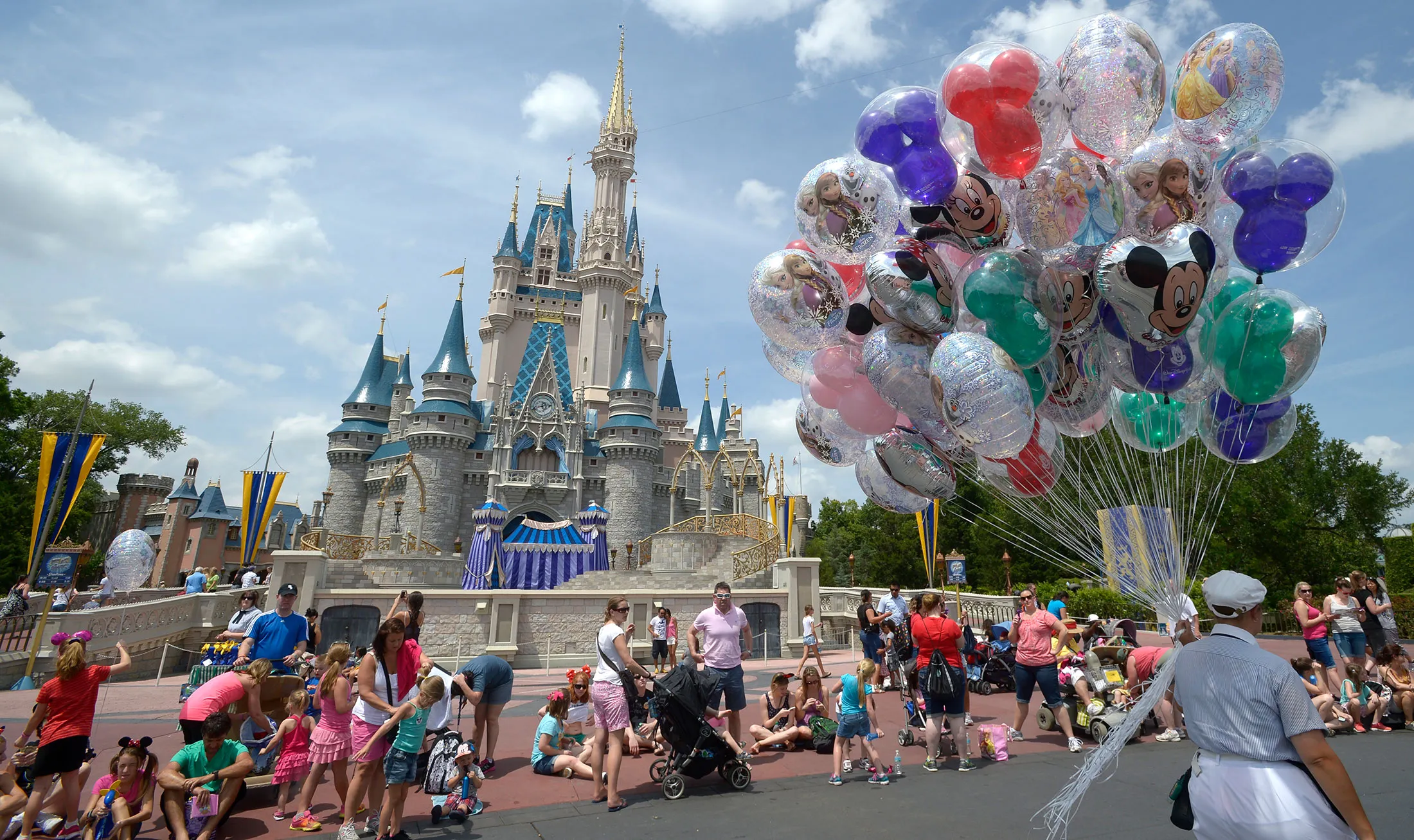A cast member sells balloons in front of Cinderella Castle at Walt Disney World's Magic Kingdom theme park in Lake Buena Vista, Fla., Saturday, May 10, 2014.
