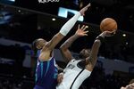 Brooklyn Nets guard Kyrie Irving scores his 50th point in the game past Charlotte Hornets forward P.J. Washington during the second half of an NBA basketball game on Tuesday, March 8, 2022, in Charlotte, N.C. (AP Photo/Chris Carlson)