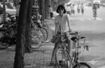 A young woman rides her bike on Beijing’s Dungtan Street in 1981.